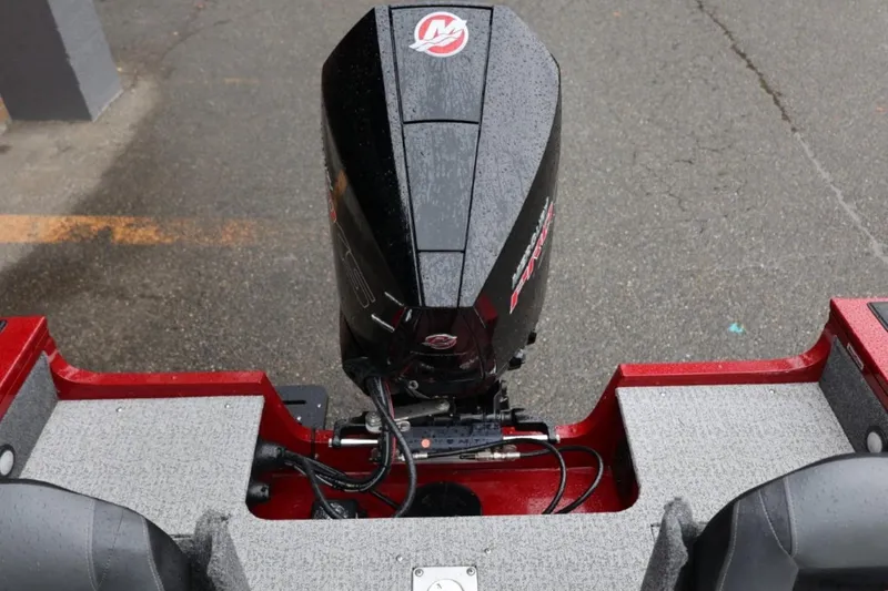 Slide: The Image of 2022 Tracker Targa V-19 Combo Tournament Edition boat engine, wet surface, red and gray design. - 73