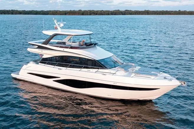 The Image of Luxury 2026 Princess F65 yacht cruising on scenic waters near lush hillside homes. - 0