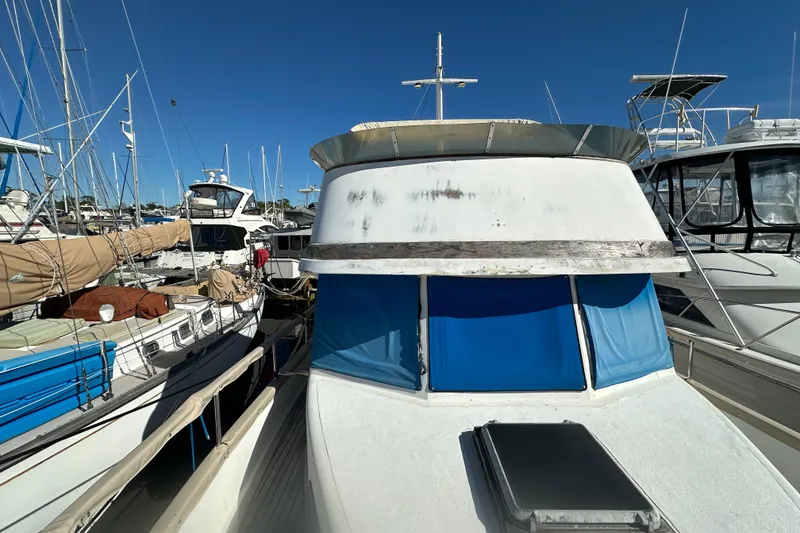 Slide: The Image of 1979 Marine Trader 38DC docked among other boats under clear blue sky. - 12