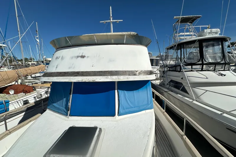 Slide: The Image of 1979 Marine Trader 38DC yacht docked among other boats under clear blue sky. - 13