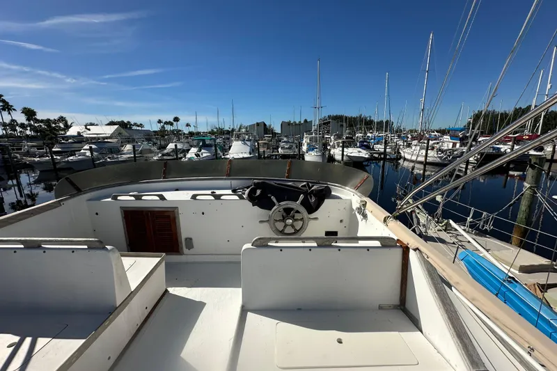 Slide: The Image of 1979 Marine Trader 38DC yacht docked in a marina under clear blue skies. - 20