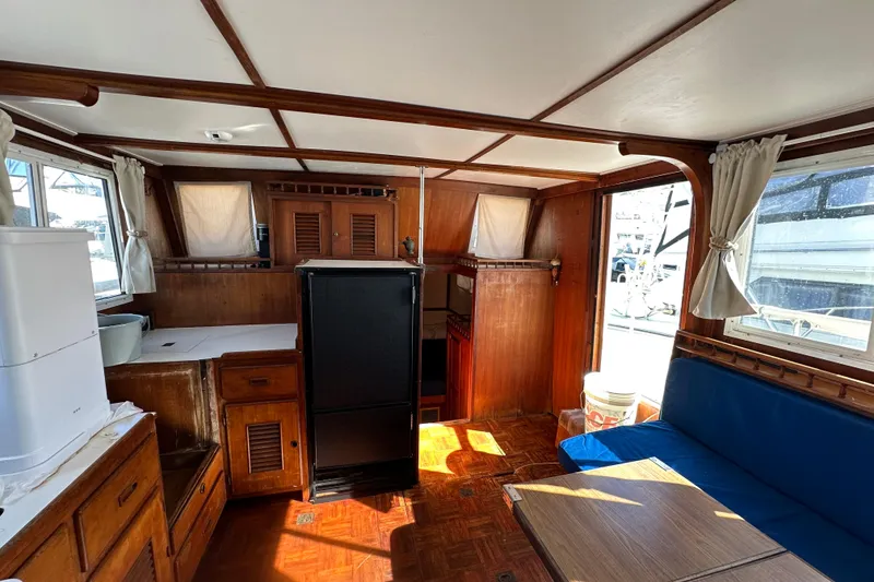 Slide: The Image of Interior of 1979 Marine Trader 38DC yacht with wooden cabinetry and seating area. - 29