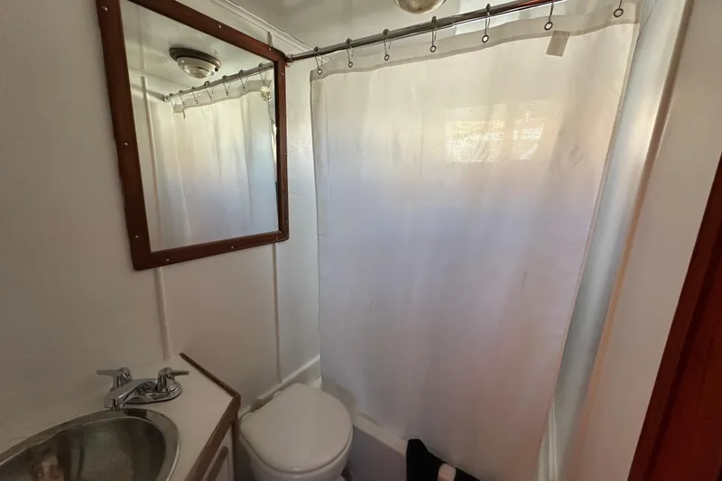 Slide: The Image of 1979 Marine Trader 38DC bathroom with shower, sink, and mirror. - 36