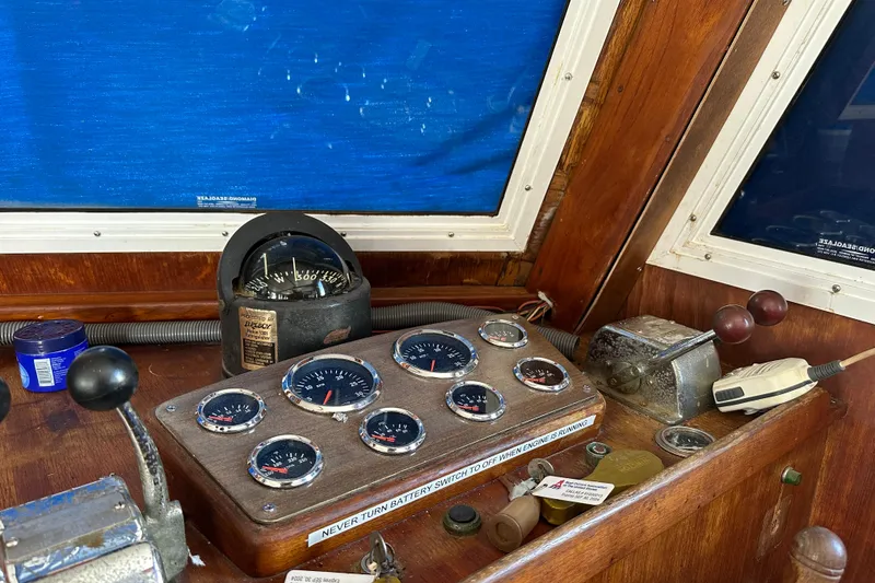 Slide: The Image of 1979 Marine Trader 38DC dashboard with gauges and controls in a wooden cabin. - 39