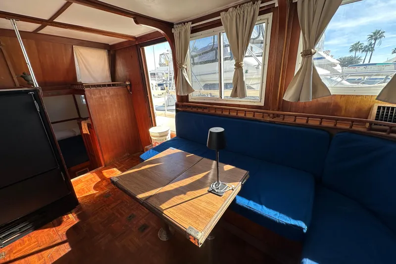 Slide: The Image of Interior of 1979 Marine Trader 38DC yacht with wooden decor and blue seating. - 42