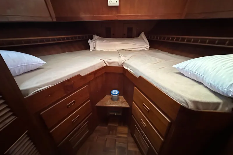 Slide: The Image of Cozy cabin interior of 1979 Marine Trader 38DC with twin beds and wooden storage. - 44