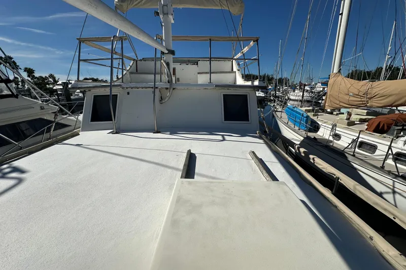 Slide: The Image of 1979 Marine Trader 38DC yacht docked at marina under clear blue sky. - 5