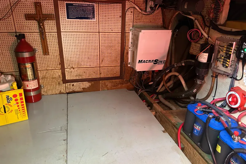 Slide: The Image of Engine room of 1979 Marine Trader 38DC with fire extinguisher and electrical components. - 50
