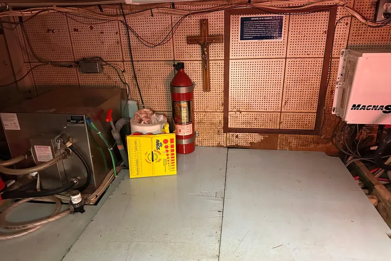 Slide: The Image of Engine room of 1979 Marine Trader 38DC with fire extinguisher and equipment. - 51