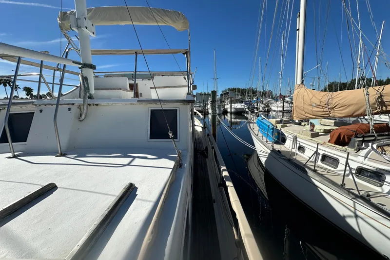 Slide: The Image of 1979 Marine Trader 38DC docked at marina under clear blue sky. - 7