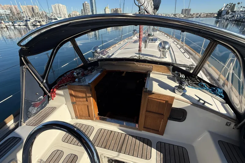 Slide: The Image of Cockpit view of 1985 Passport 40 sailboat docked in marina, city skyline in background. - 10