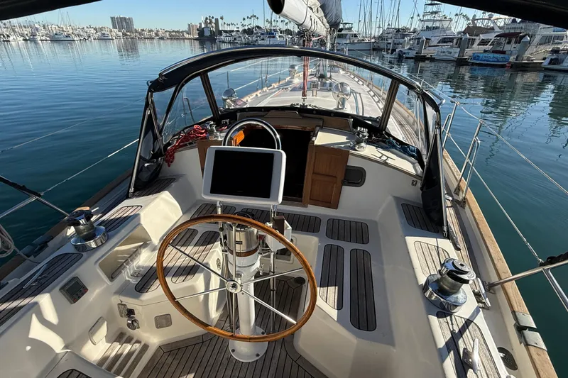 Slide: The Image of Cockpit view of a 1985 Passport 40 sailboat docked in a marina. - 11