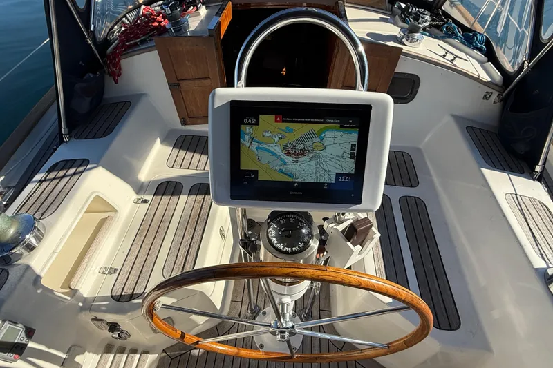 Slide: The Image of Cockpit of 1985 Passport 40 sailboat with navigation system and wooden steering wheel. - 12