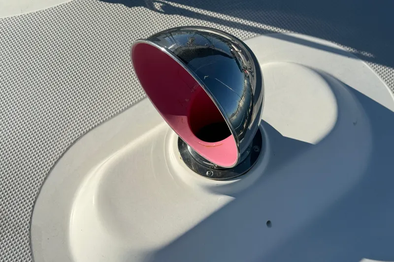 Slide: The Image of Chrome vent on 1985 Passport 40 yacht deck, pink interior, textured surface. - 16