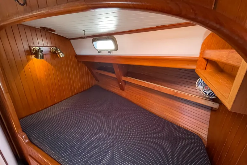 Slide: The Image of Cozy wooden cabin interior of 1985 Passport 40 sailboat with bed and lighting. - 25