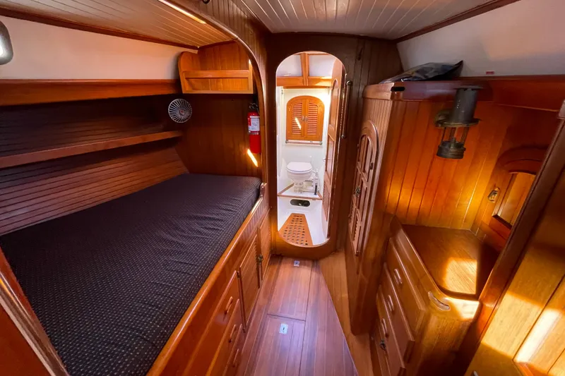 Slide: The Image of Cozy 1985 Passport 40 yacht interior with wooden cabin and compact bathroom. - 26