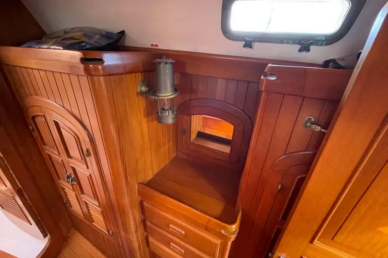 Slide: The Image of Interior of 1985 Passport 40 sailboat with wooden cabinetry and porthole window. - 27