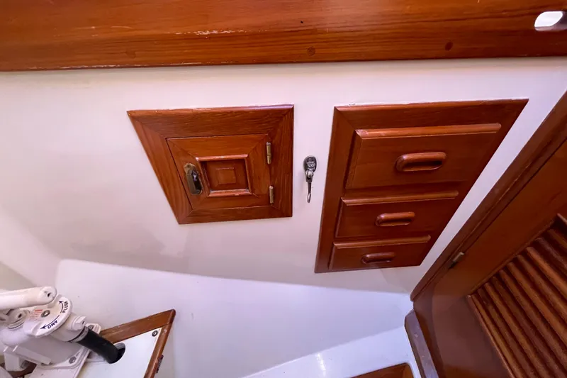 Slide: The Image of Wooden cabinetry and stairs inside a 1985 Passport 40 sailboat interior. - 30