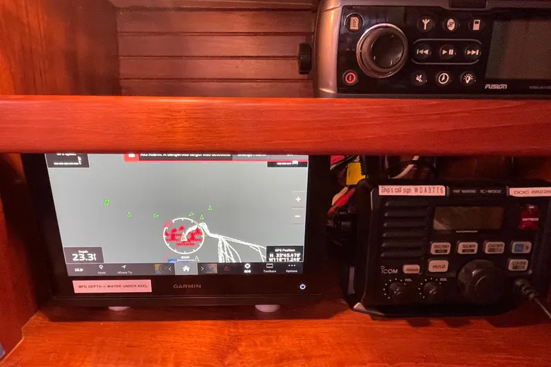Slide: The Image of Navigation equipment on a 1985 Passport 40 sailboat, featuring Garmin and Icom devices. - 32