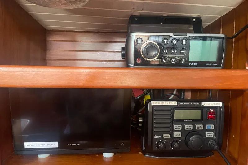 Slide: The Image of Marine electronics setup on a 1985 Passport 40, featuring Garmin and Icom devices. - 34