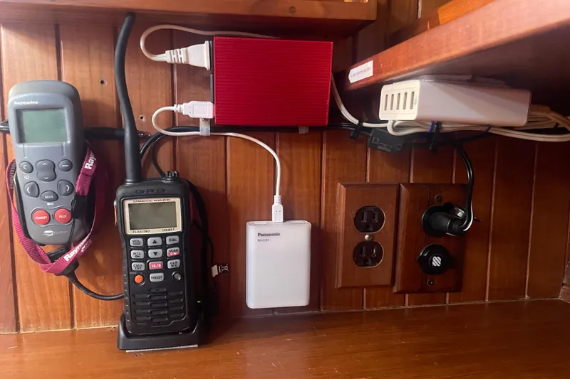 Slide: The Image of Electronics setup on a 1985 Passport 40 boat, featuring communication devices and power outlets. - 35