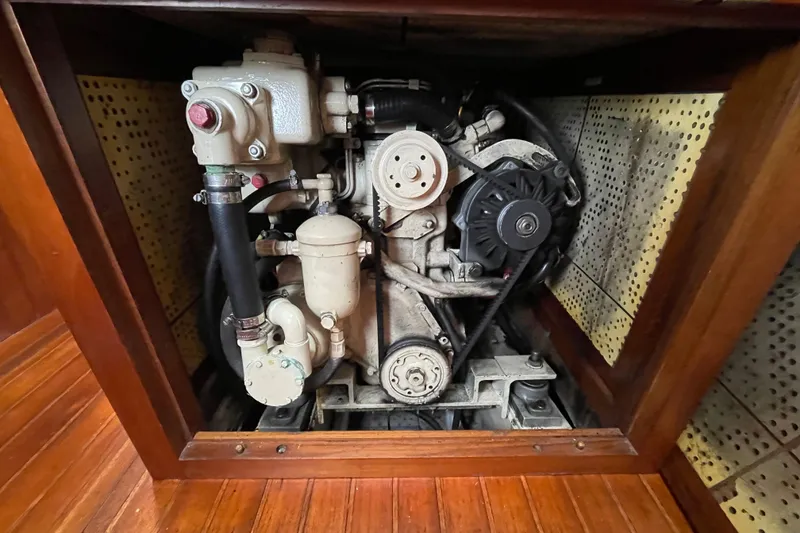 Slide: The Image of Engine compartment of a 1985 Passport 40 sailboat, showcasing mechanical components. - 38