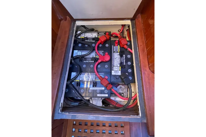 Slide: The Image of Battery compartment of a 1985 Passport 40 sailboat with wiring and connections. - 40