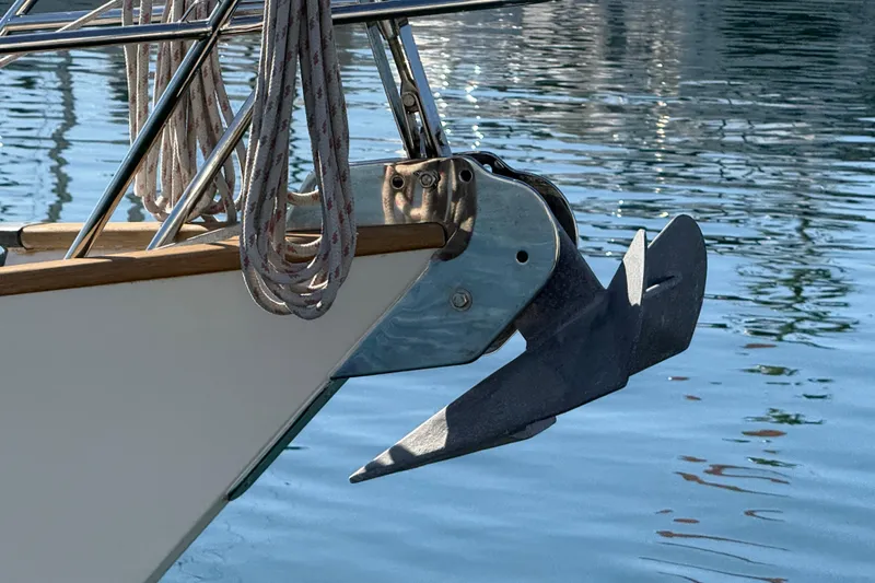 Slide: The Image of Bow of 1985 Passport 40 sailboat with anchor and ropes over water. - 7