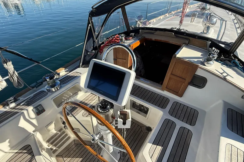 Slide: The Image of Cockpit of 1985 Passport 40 sailboat with steering wheel and navigation equipment. - 8