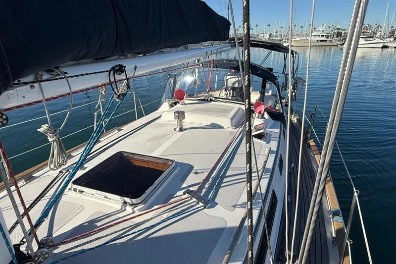 Slide: The Image of Sailboat deck view of 1985 Passport 40, docked in a marina. - 9