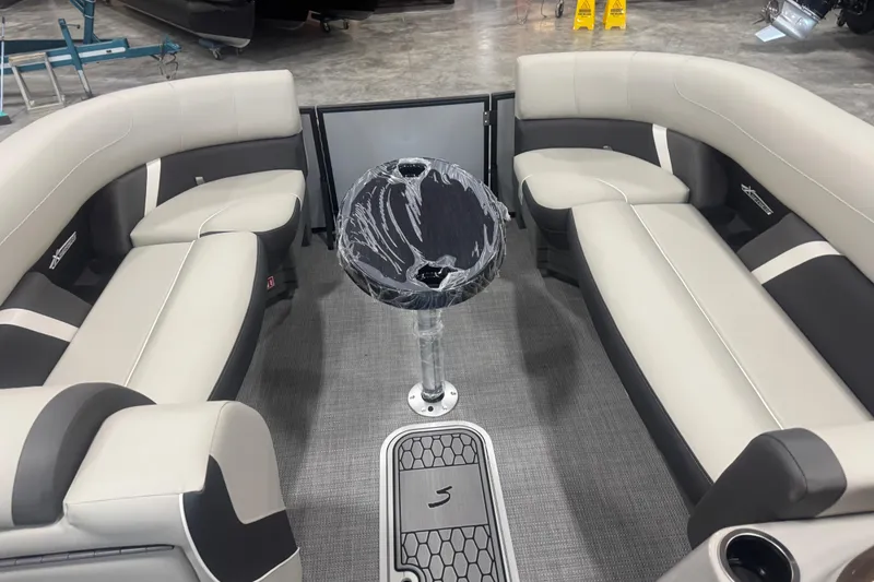 Slide: The Image of 2026 Sylvan Mirage X X5 boat interior with sleek seating and modern table design. - 11