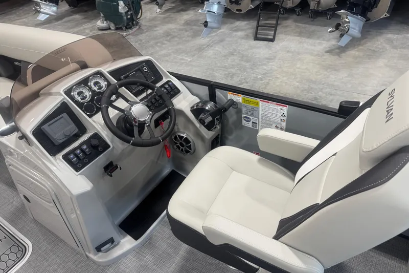 Slide: The Image of 2026 Sylvan Mirage X X5 boat cockpit with modern steering and controls. - 12