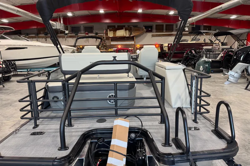 Slide: The Image of 2026 Sylvan Mirage X X5 pontoon boat in showroom, featuring sleek design and modern seating. - 5