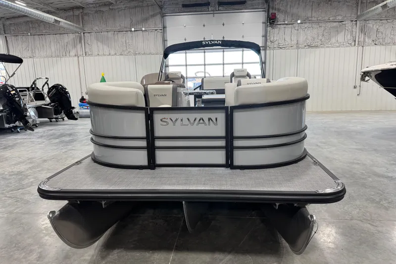 Slide: The Image of 2026 Sylvan Mirage X X5 pontoon boat in showroom, rear view. - 6