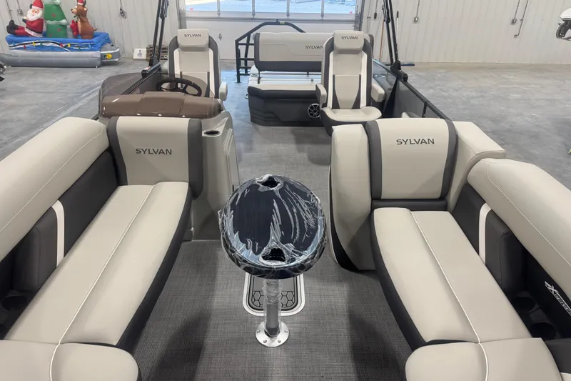 Slide: The Image of 2026 Sylvan Mirage X X5 pontoon boat interior with plush seating and modern design. - 7