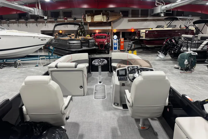 Slide: The Image of 2026 Sylvan X 5 boat interior with modern dashboard and seating in showroom. - 10