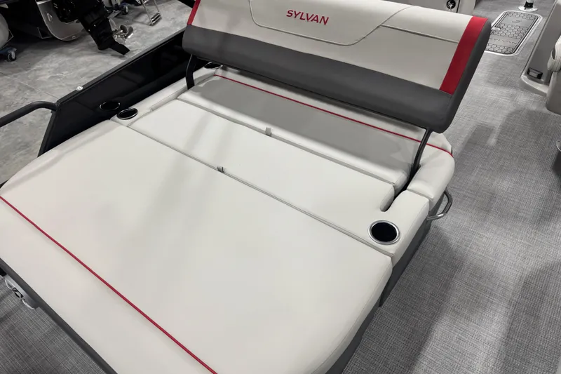 Slide: The Image of 2026 Sylvan X 5 boat interior with gray and red cushioned seating and cup holders. - 11