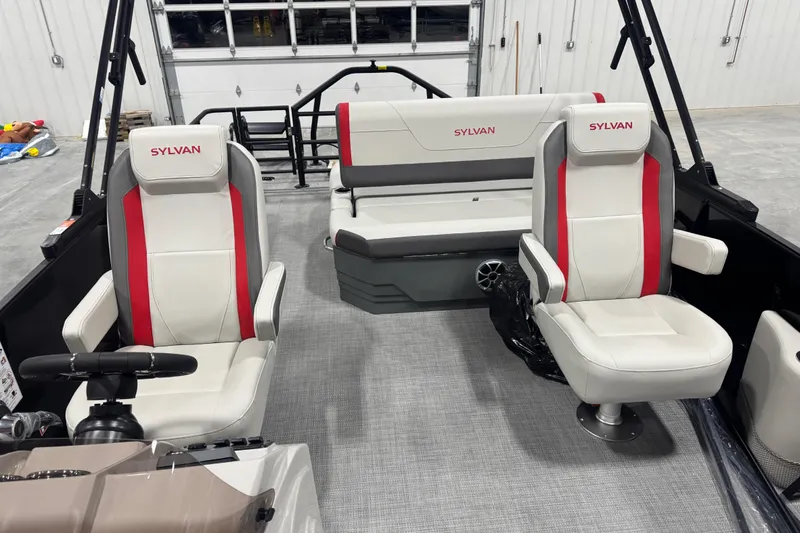 Slide: The Image of 2026 Sylvan X 5 boat interior with white and red seating in a garage setting. - 13