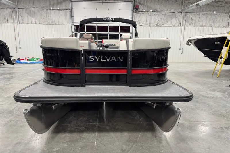 Slide: The Image of 2026 Sylvan X 5 pontoon boat in a showroom, rear view. - 5