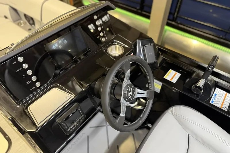 Slide: The Image of 2025 Veranda VX 22 RC boat dashboard with steering wheel and control panel. - 2
