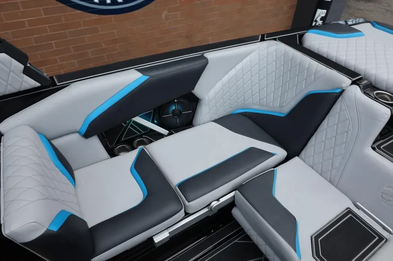 Slide: The Image of 2022 Tigé 24RZX boat interior with stylish gray and blue seating. - 14