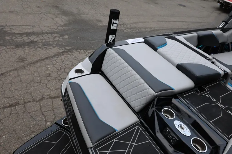 Slide: The Image of 2022 Tigé 24RZX boat interior with stylish seating and cup holders. - 2