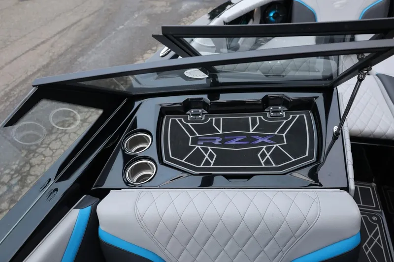 Slide: The Image of 2022 Tigé 24RZX boat interior with cup holders and RZX logo detailing. - 21