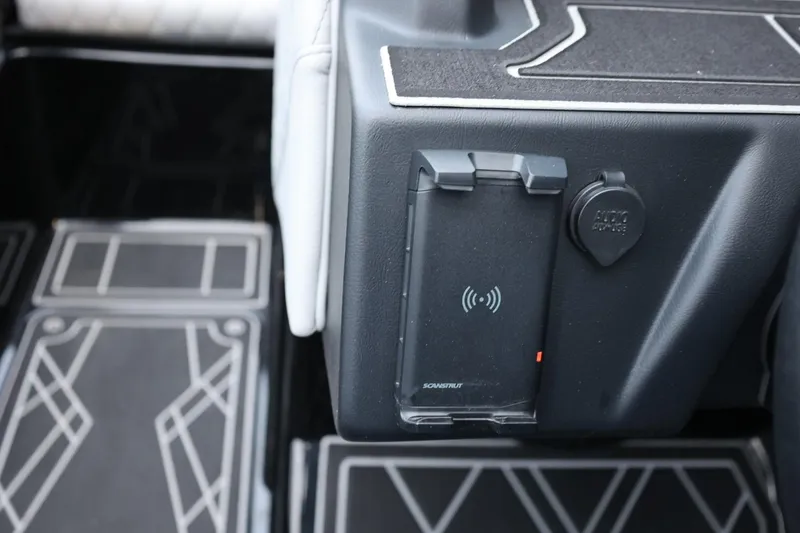 Slide: The Image of 2022 Tigé 24RZX interior with wireless charging pad and audio input. - 29