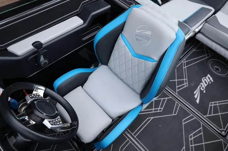 Slide: The Image of 2022 Tigé 24RZX boat interior with blue and gray captain's seat and steering wheel. - 31