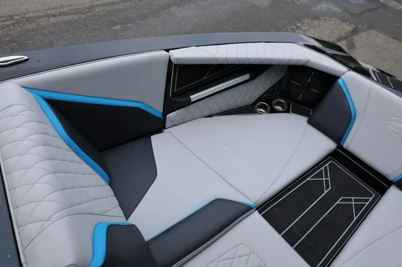 Slide: The Image of 2022 Tigé 24RZX boat interior with modern, stylish seating and blue accents. - 33