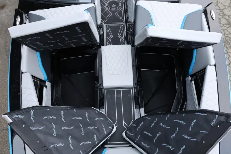 Slide: The Image of 2022 Tigé 24RZX boat interior with open storage compartments and cushioned seating. - 38