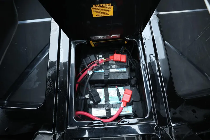 Slide: The Image of 2022 Tigé 24RZX boat battery compartment with red and black cables. - 40