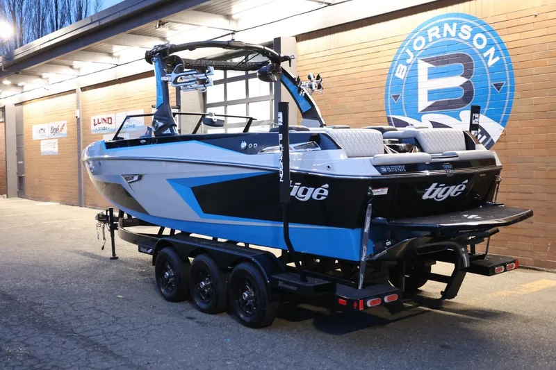 Slide: The Image of 2022 Tigé 24RZX boat on trailer, displayed outside Bjornson dealership. - 46