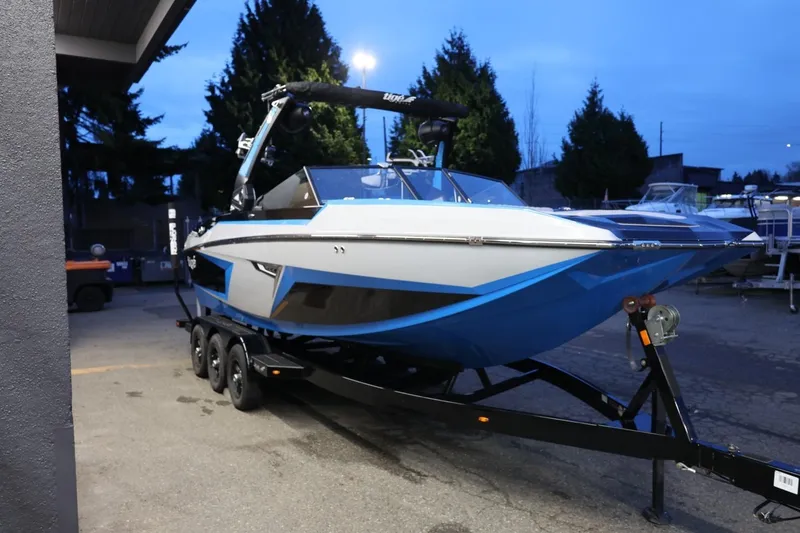 Slide: The Image of 2022 Tigé 24RZX boat on trailer, parked outdoors at dusk. - 52